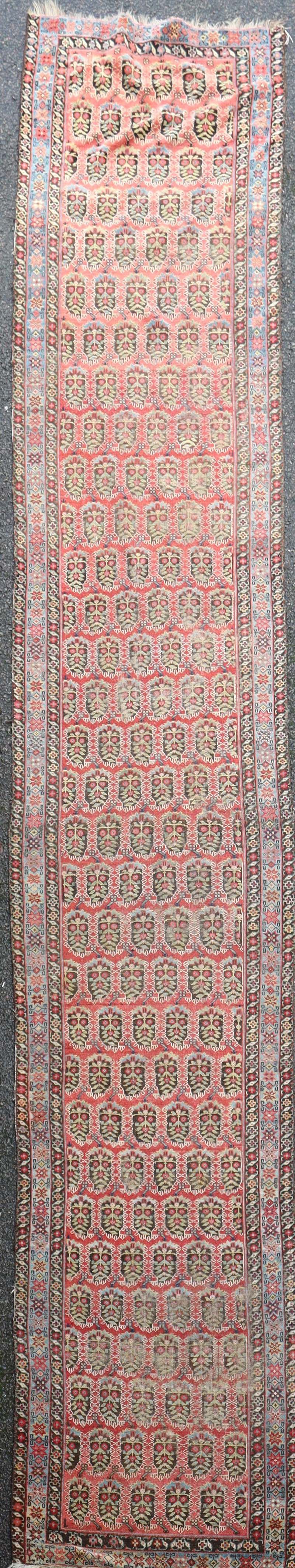 An antique Fereghan red ground runner, 16ft 6in by 3ft 6in.